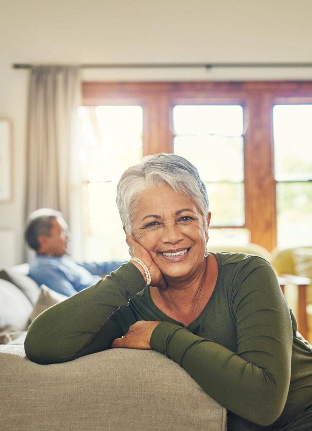 A resident relaxing on the sofa in the living room