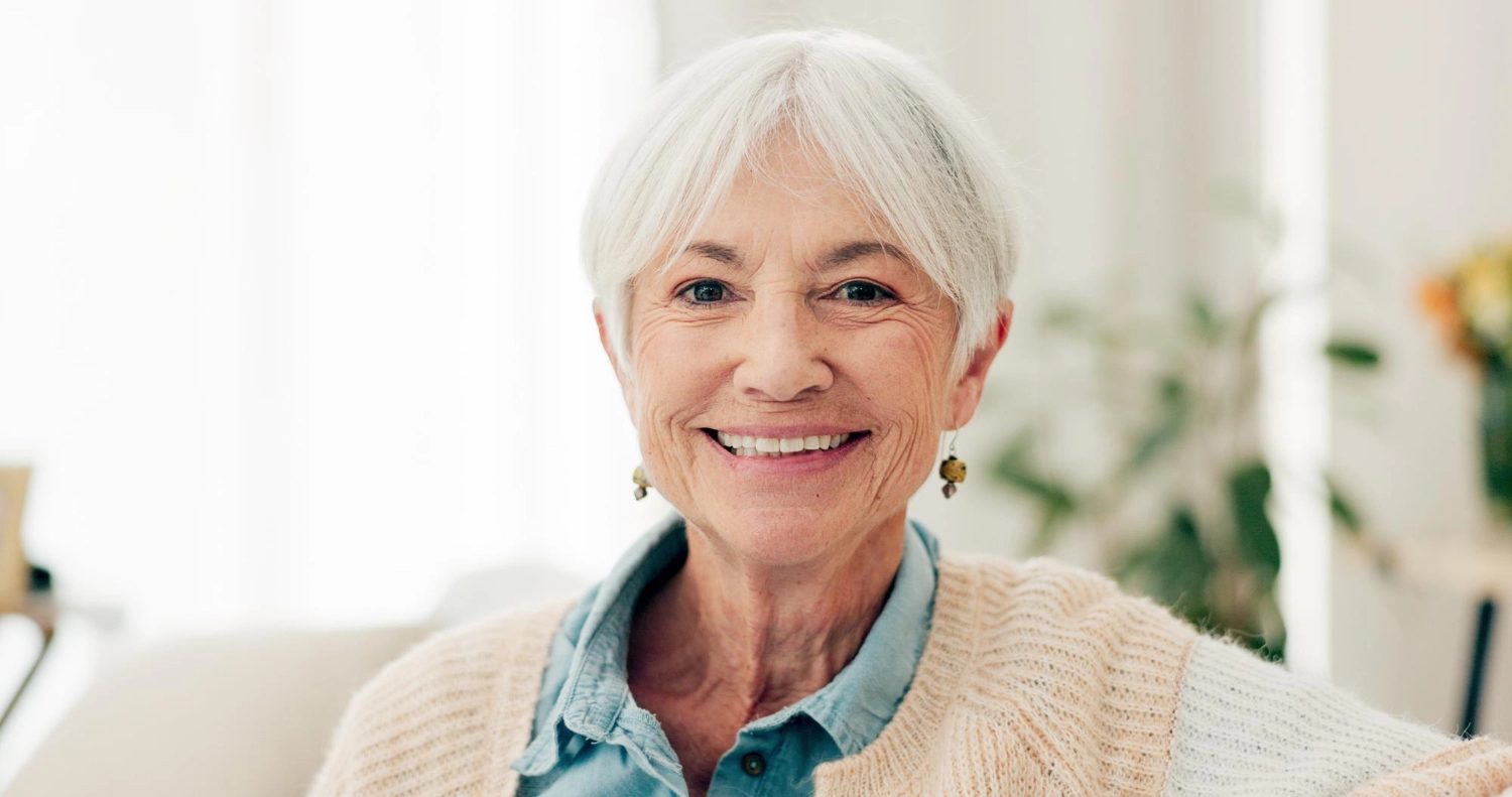 A resident smiling, wearing a blue collared top